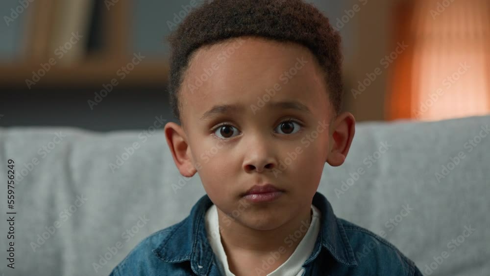 Portrait sad cute African American ethnic multiracial multiethnic child orphan small boy pupil son baby toddler serious 7 years kid looking at camera upset facial expression loneliness discrimination Portrait sad cute African American ethnic multiracial multiethnic child orphan small boy pupil son baby toddler serious 7 years kid looking at camera upset facial expression loneliness discrimination