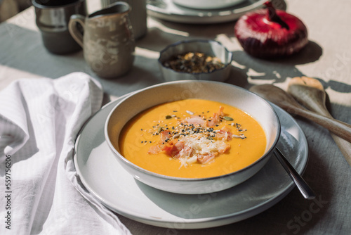 Tasty pumpkin soup with seeds and bacon. Vegetable seasonal soup. Family dinner.