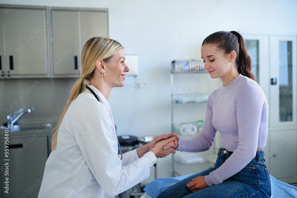 Fototapeta premium Young woman doctor examining teenage girl in her ambulance.
