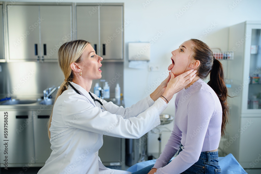 Young woman doctor examining teenage girl in her ambulance. Young woman doctor examining teenage girl in her ambulance.