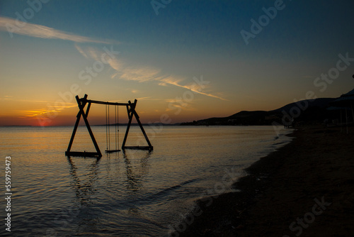 Swinging in the sea against the sunset.