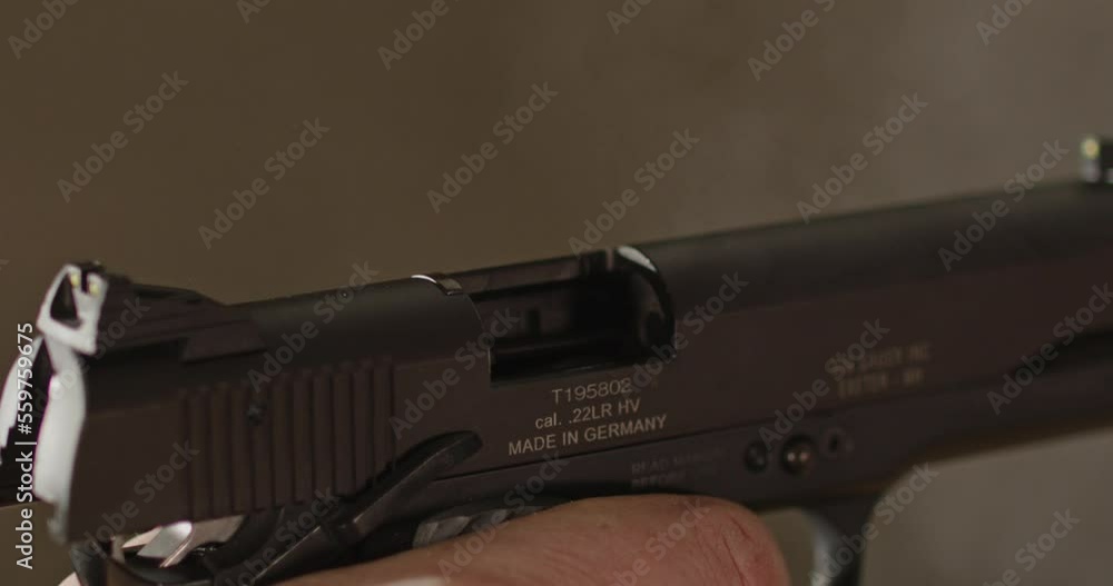 Pistol being fired in slow motion and shell casing flying out Pistol being fired in slow motion and shell casing flying out