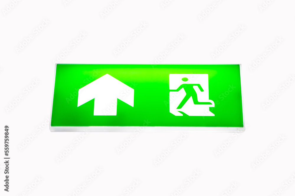 Fire exit green emergency exit signs. Escape sign hang on ceiling in the dark building near stairway. warning plate with running man icon and arrow to straight on way. isolated on white background. Fire exit green emergency exit signs. Escape sign hang on ceiling in the dark building near stairway. warning plate with running man icon and arrow to straight on way. isolated on white background.
