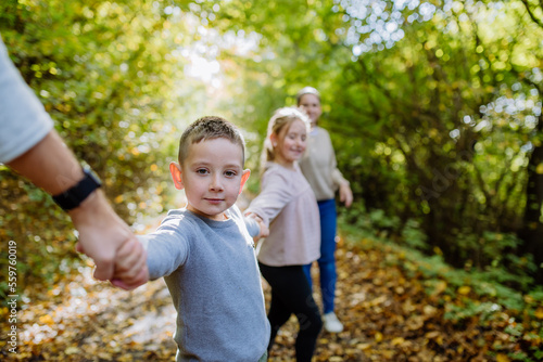 Close-up of family with kids walking in forest. © Halfpoint