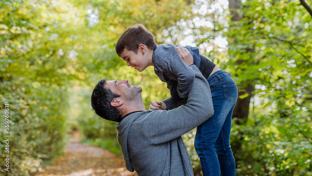 Father having fun with his son in forest. Father having fun with his son in forest.