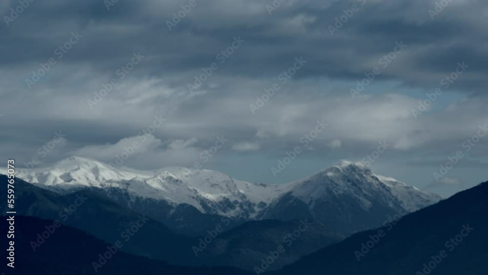 Time laps of mountain peaks and clouds. White clouds glide between the mountain peaks. Mountain delightful landscape Time laps of mountain peaks and clouds. White clouds glide between the mountain peaks. Mountain delightful landscape