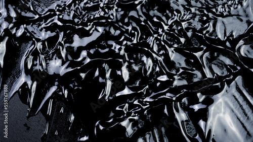 Liquid Serum on black background.
Gel Cream with bubbles smudged.  Petroleum crude oil.