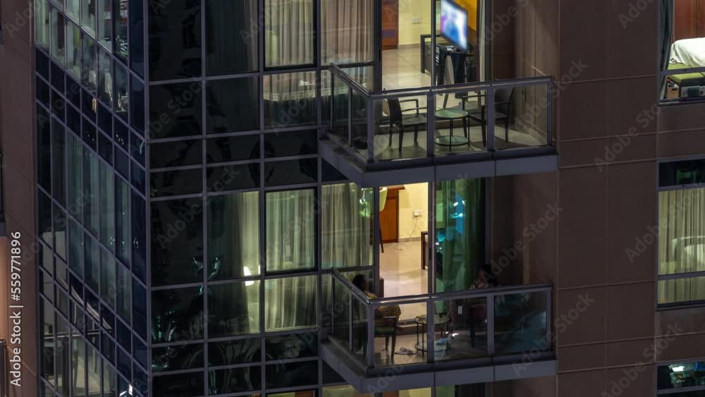 Night view of glowing panoramic windows in apartment building timelapse. High rise skyscraper with lights in rooms. Night view of glowing panoramic windows in apartment building timelapse. High rise skyscraper with lights in rooms.