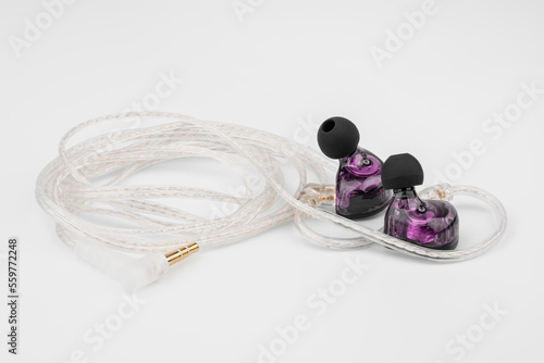 In ear monitor on a tablature background. Custom in-ear monitors with black plates. Custom in ear monitors or IEMs ready for a musician to wear on stage at a concert. photo
