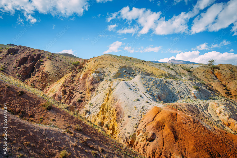 Obraz premium Amazing panorama of rainbow mountains and blue sky. Colorful landscape, unusual sandstone hills and vast open spaces in asian steppe.