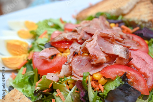 Salad with fresh vegetables and bacon.