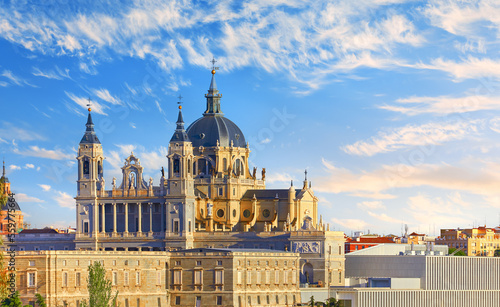 Madrid, Spain. Royal Palace. Cathedral Santa Maria la Real de Almudena at Plaza Armeria. Famous landmark with sunset and picturesque sky clouds