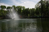 a beautiful large park with well-groomed animals and a river in the city