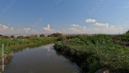 A stream of clean water against a cloudy sky, in Agmon Hula Nature Reserve - Northern Israel photo