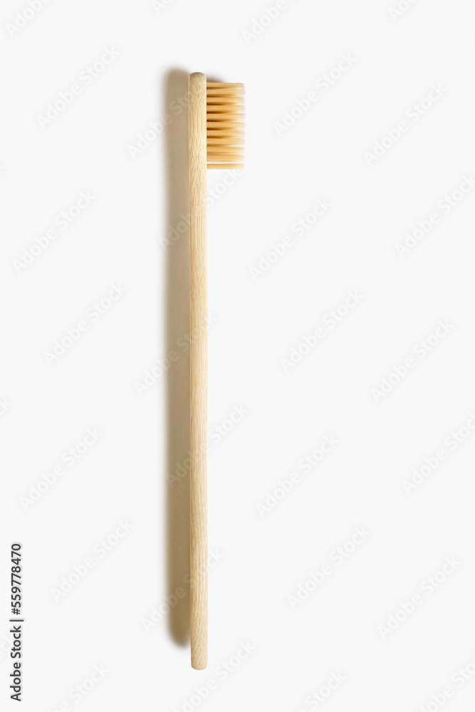 Wooden toothbrush on a white isolated background. Eco-friendly plastic-free toothbrush. Waste-free personal care products, dental care concept