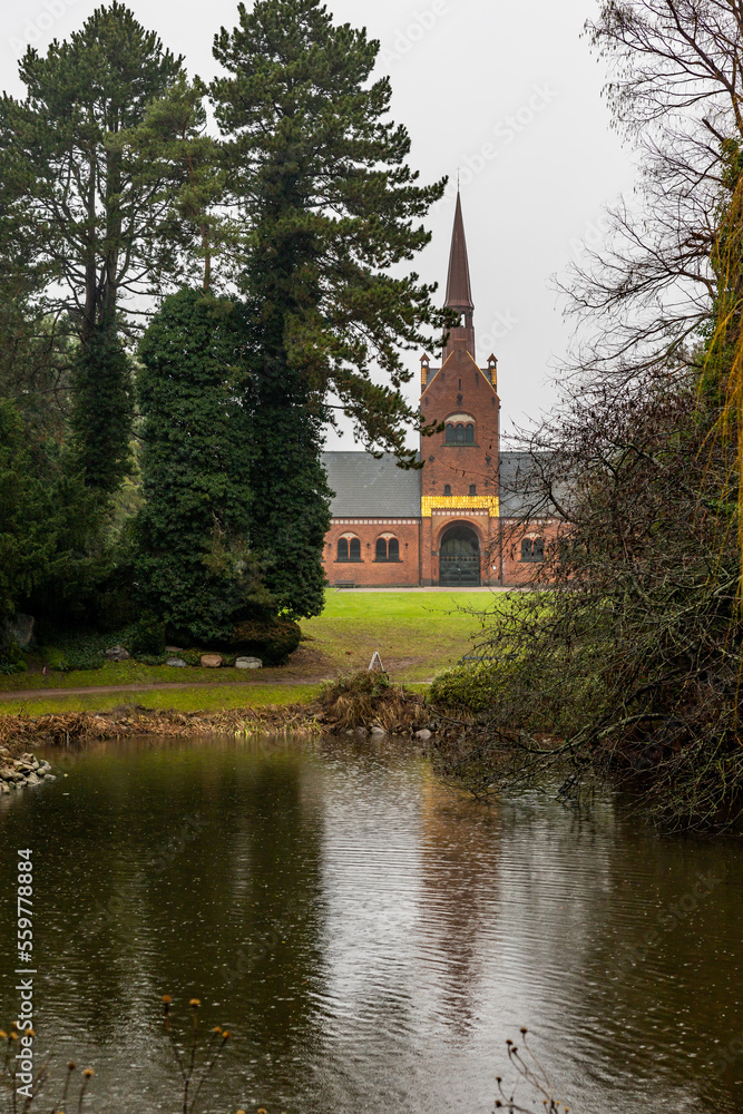 Copenhagen, Denmark  The North Chapel in the Western Cemetery on a winter day and a small pond.