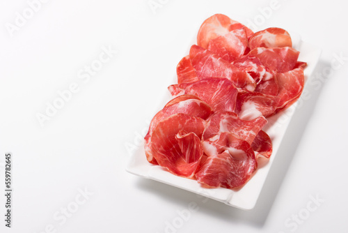 Italian slices of coppa, capocollo, capicollo, bresaola or cured ham with rosemary. Raw food.  