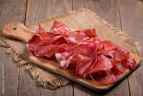 Italian slices of coppa, capocollo, capicollo, bresaola or cured ham with rosemary. Raw food.  