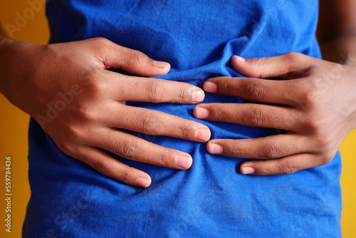  boy suffering stomach pain close up.