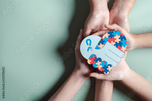 Wallpaper Mural Father, Mother, Children holding heart jigsaw puzzle, Color puzzle symbol of awareness for autism spectrum disorder family support. Autism World Awareness Day. Torontodigital.ca