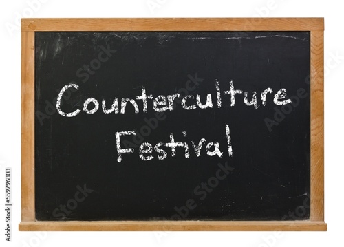Counterculture festival written in white chalk on a black chalkboard isolated on white