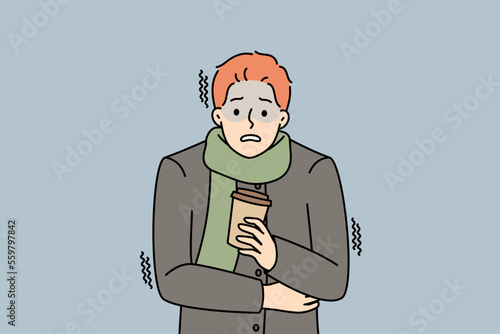 Unhappy young man in outerwear hold takeaway coffee freezing outdoors. Distressed guy with warm drink in hands suffer from cold weather. Vector illustration. 