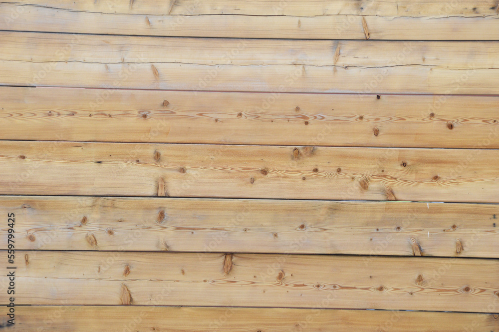 Naklejka premium Light brown horizontal wooden planks with a natural natural pattern. Background or texture of a wooden wall.