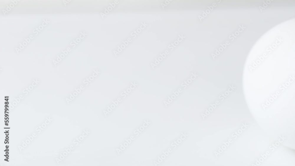 Easter eggs background. White egg are rolling on the white table.