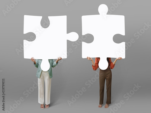 Two woman holding the big white jigsaw concept of teamwork idea.