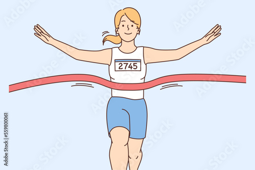 Smiling female athlete at finish line 