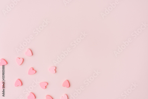 Small hearts in the corner of a pink background.