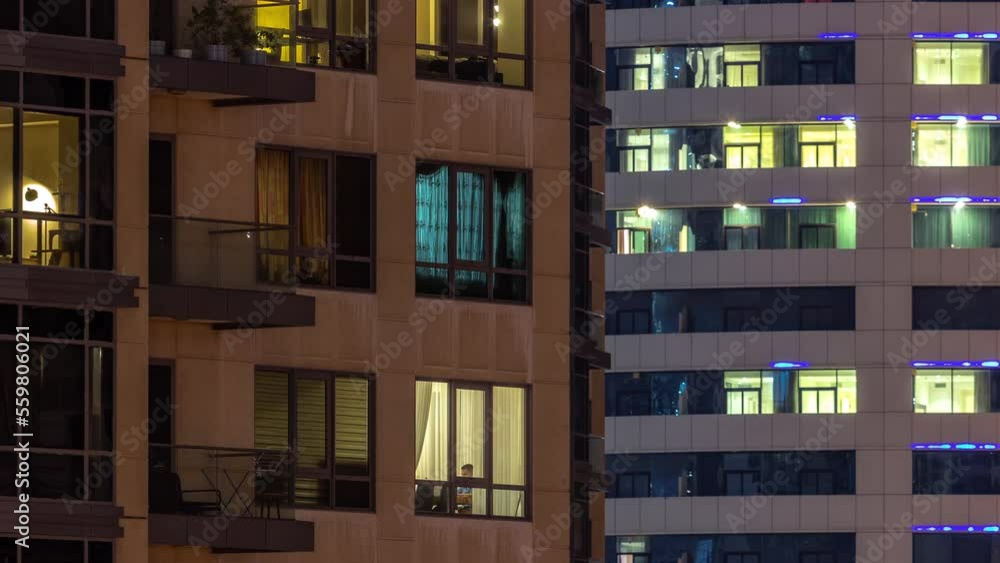 Full of the light windows in the skyscrapers at night in the modern city timelapse. Glowing illuminationin of residential buildings Full of the light windows in the skyscrapers at night in the modern city timelapse. Glowing illuminationin of residential buildings
