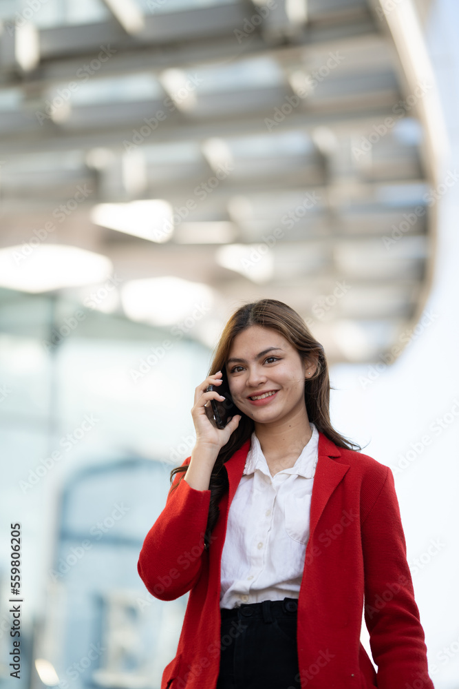 Young asian businesswoman using smart phone in office.. Young asian businesswoman using smart phone in office..