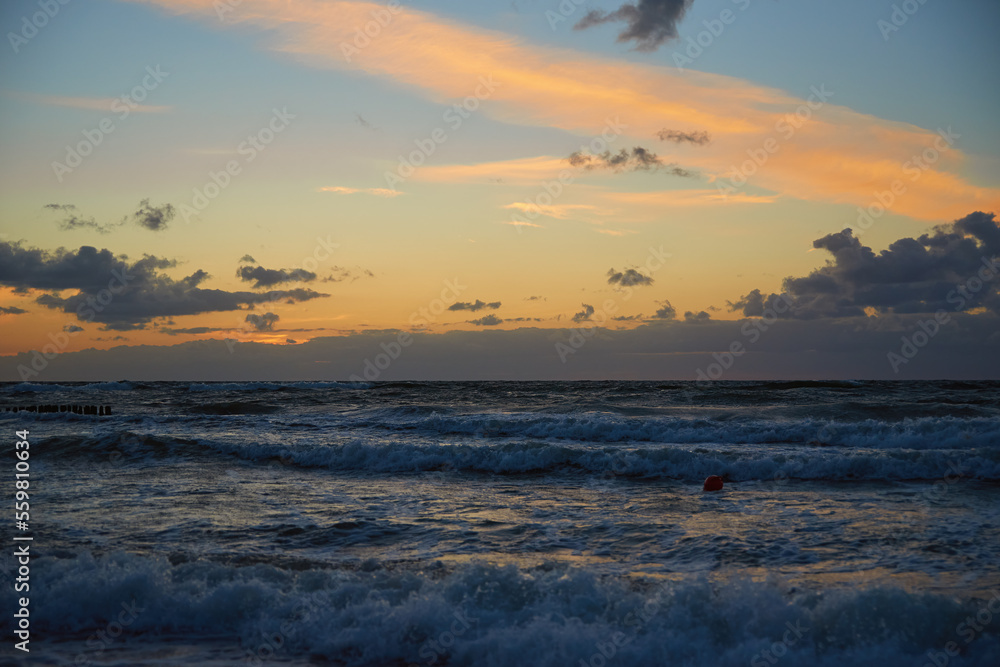 Panoramic view of sea landscape against sunset. Baltic sea coastline with waves and beautiful cloudy sky Panoramic view of sea landscape against sunset. Baltic sea coastline with waves and beautiful cloudy sky