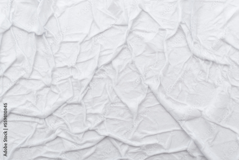 Naklejka premium Texture of crumpled wet white paper with folds. writing paper