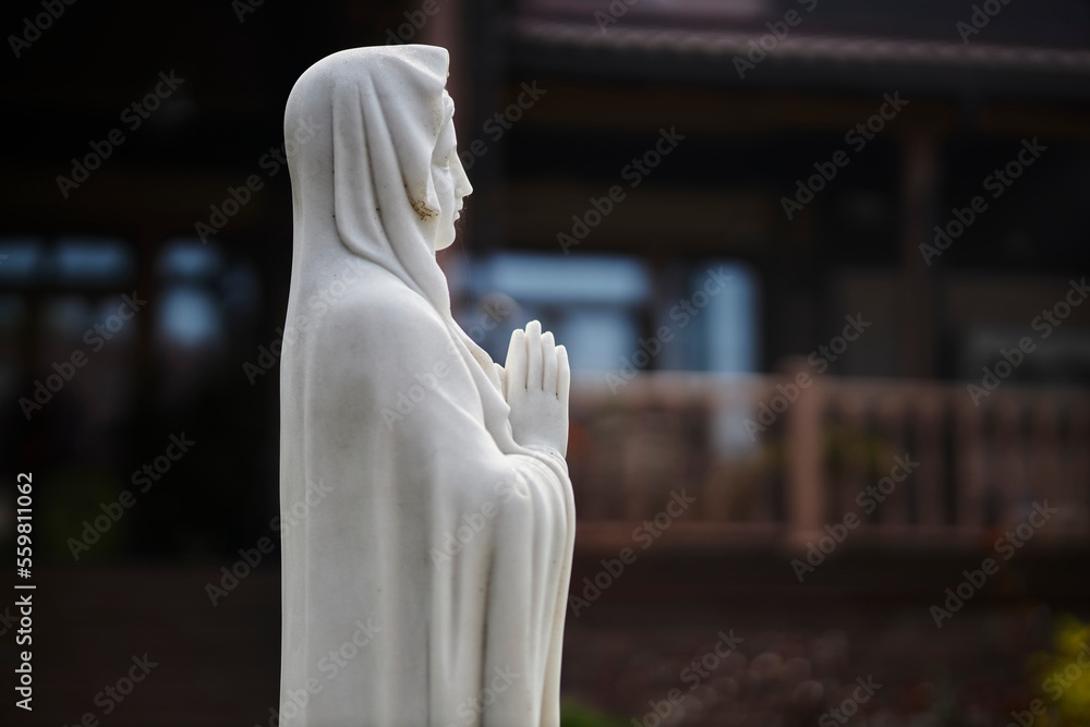 Sculpture of Mary Magdalene. Statue of Mary Magdalene in the garden