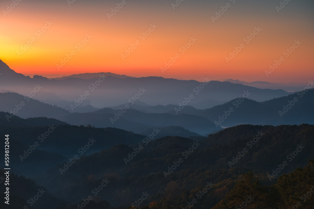 Scenery of sunrise over Doi Kham Fah mountain peak with foggy in tropical rainforest at national park, Chiang Dao, Chiang Mai