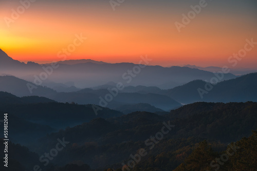 Scenery of sunrise over Doi Kham Fah mountain peak with foggy in tropical rainforest at national park, Chiang Dao, Chiang Mai