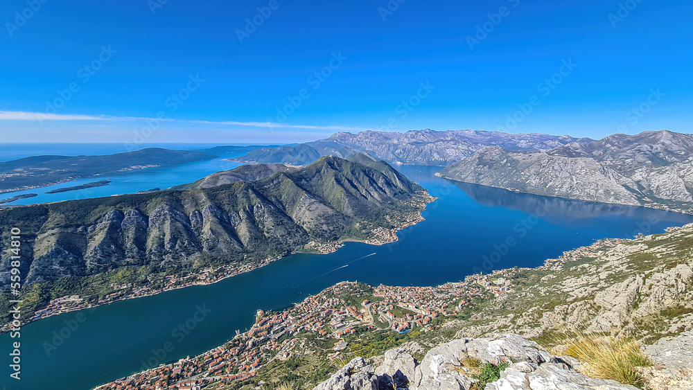 Panoramic view from Pestingrad (Derinski Vrh) of Kotor bay in sunny summer, Adriatic Mediterranean Sea, Montenegro, Balkan Peninsula, Europe. Fjord winding along coastal towns. Lovcen, Orjen mountains