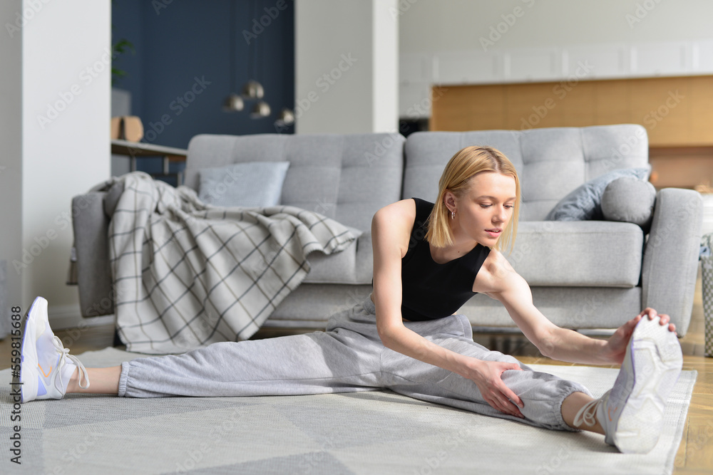 Woman doing stretching exercise at home. Woman doing stretching exercise at home.