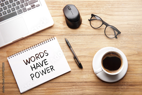Words Have Power, motivational words and sentences for work and life. Quote sentence in notebook with laptop, pen, coffee over wooden background.