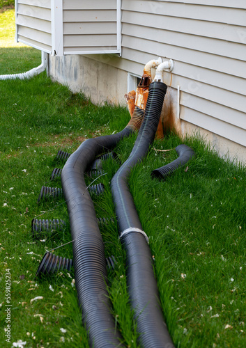 Drainage system problem. Black corrugated plastic pipe on ground. Pipes for use in outdoor.