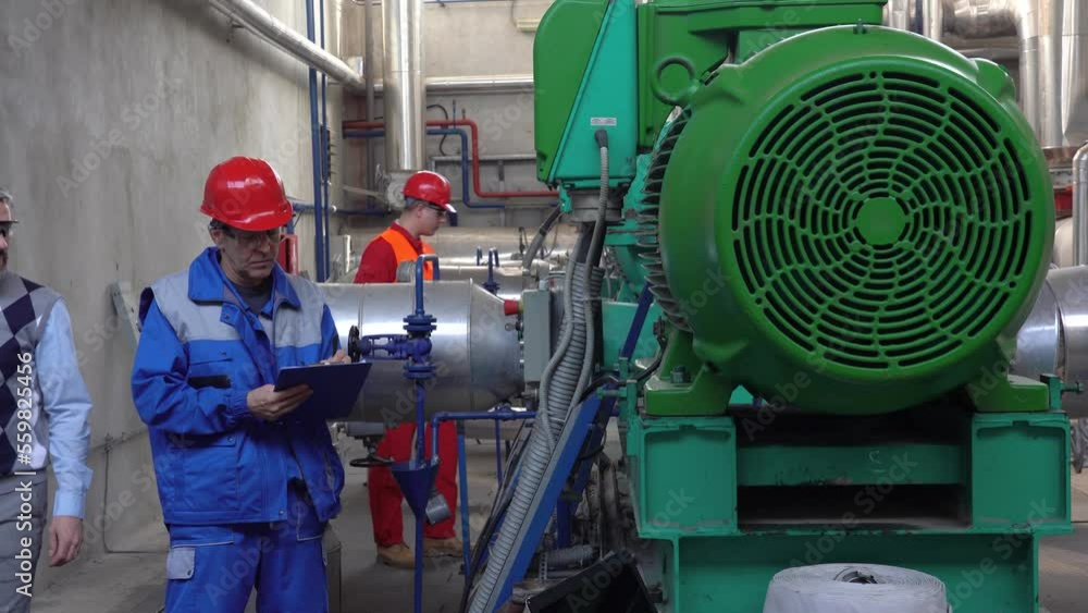 Supervisor Using Digital Tablet in Communication With Machine Operator in Personal Protective Equipment. Digital Technology and Teamwork Concept. Industry 4.0. Supervisor Using Digital Tablet in Communication With Machine Operator in Personal Protective Equipment. Digital Technology and Teamwork Concept. Industry 4.0.