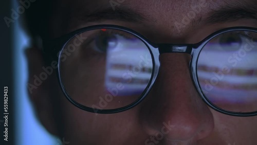 Wallpaper Mural Close-up of a man in eyeglasses browsing social networks on the Internet at night at home, computer monitor is reflected on his glasses. Man with eyeglasses internet user uses computer online at night Torontodigital.ca