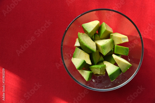 Avocado cut into small slices. Avocado salad. Peeled avocado on a plate.