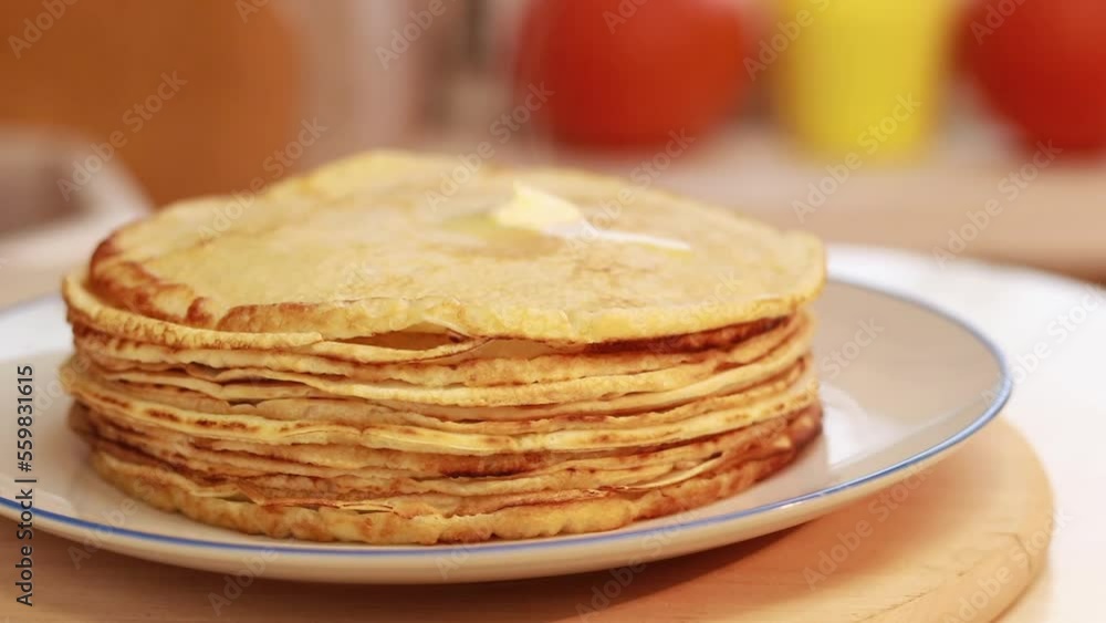 Freshly baked hot pancakes stacked in a stack. Cooking crepes, thin crepes with raised steam for morning breakfast Freshly baked hot pancakes stacked in a stack. Cooking crepes, thin crepes with raised steam for morning breakfast