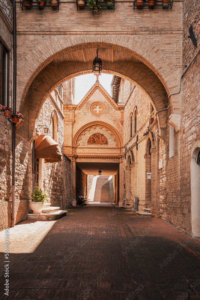 street view on a sunny day in the town of Assisi, Italy with a small chapel