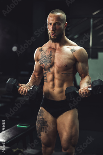 Man Doing Training With Dumbbell For His Arms Muscle At The Gym