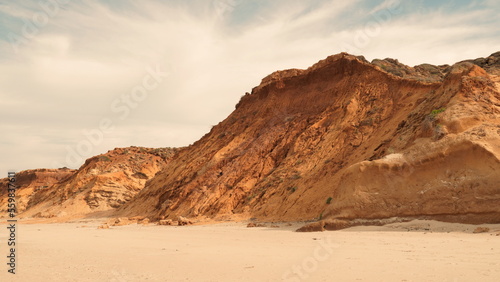 Rocky sea shore and blue sky on sunny  day. Seascape, Mediterranean coastline, layers of rock and stones