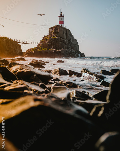 View of Basargin lighthouse along the coastline on a small island at sunrise, Vladivostok, Russia. photo